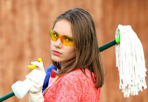 Girl with mop and spray bottle