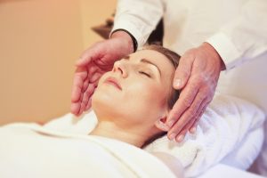 woman lying down receiving Reiki
